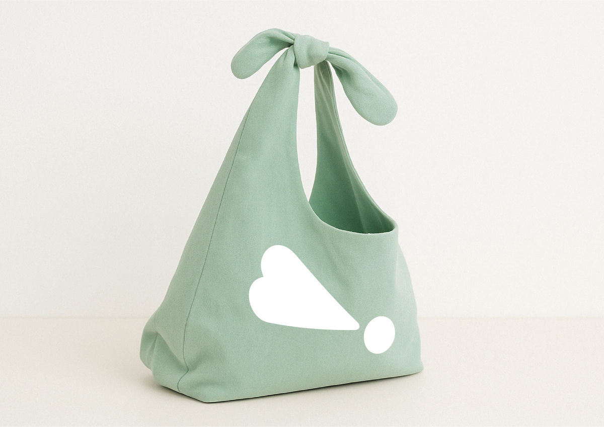 Light green bag with a bow on a white background